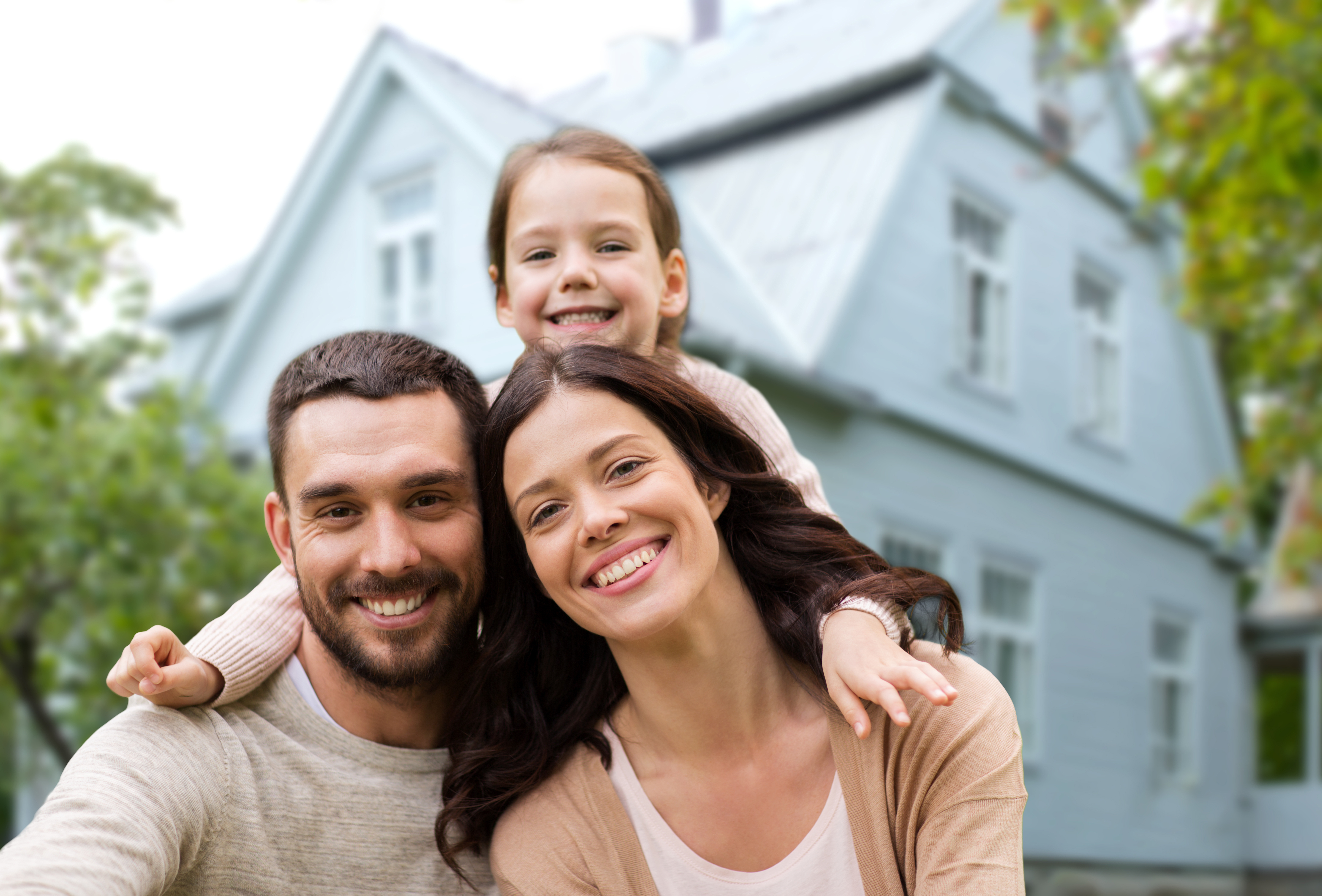 Happy family outside their home