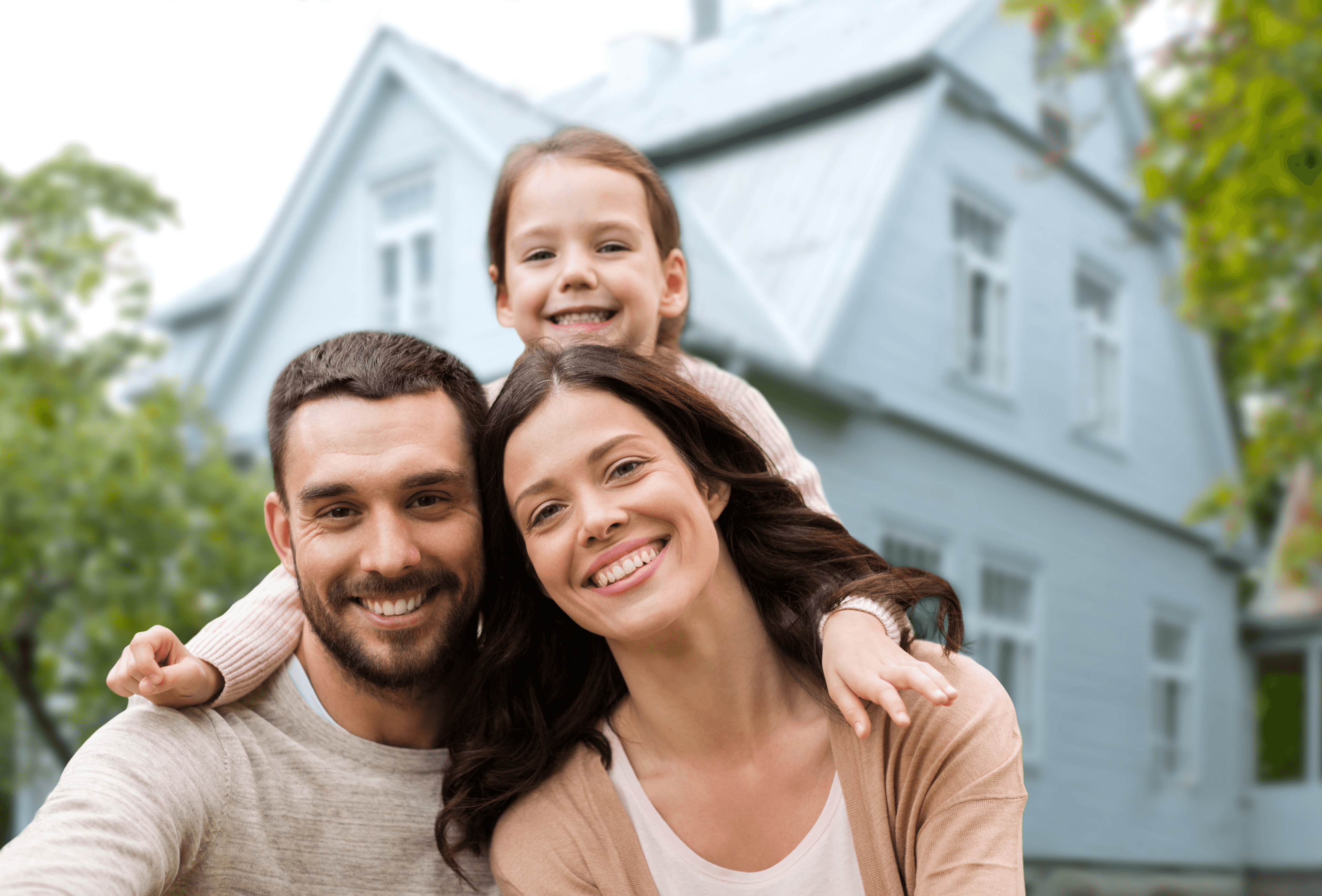Happy family outside their home